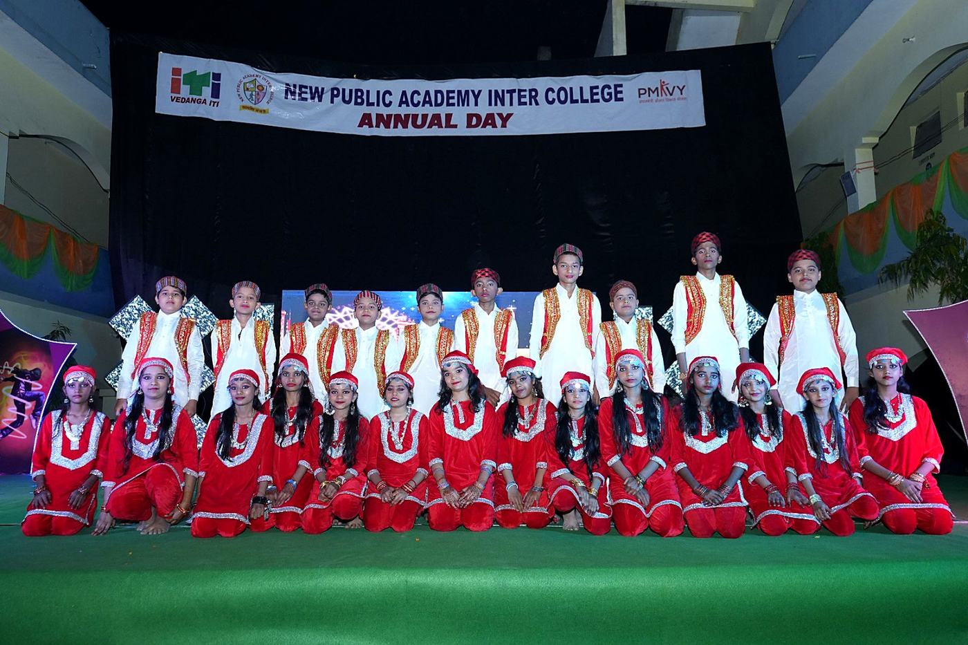 Students in red and white traditional costumes on stage