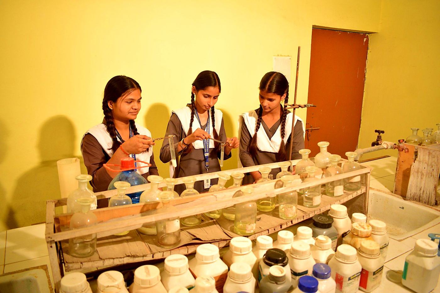Three students doing an experiment in the science lab